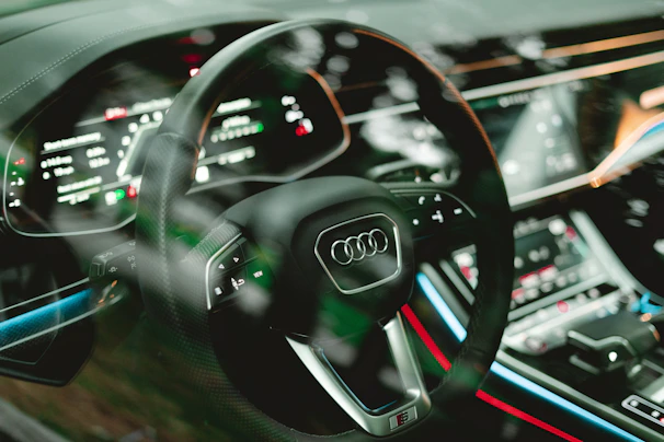 a car dashboard with a steering wheel and dashboard lights