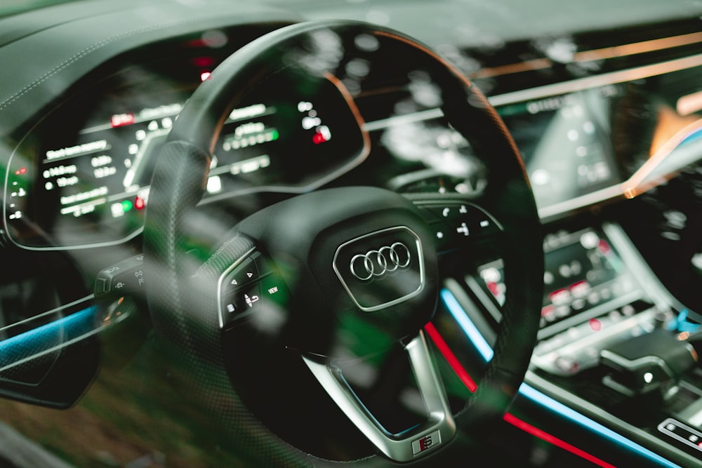 a car dashboard with a steering wheel and dashboard lights