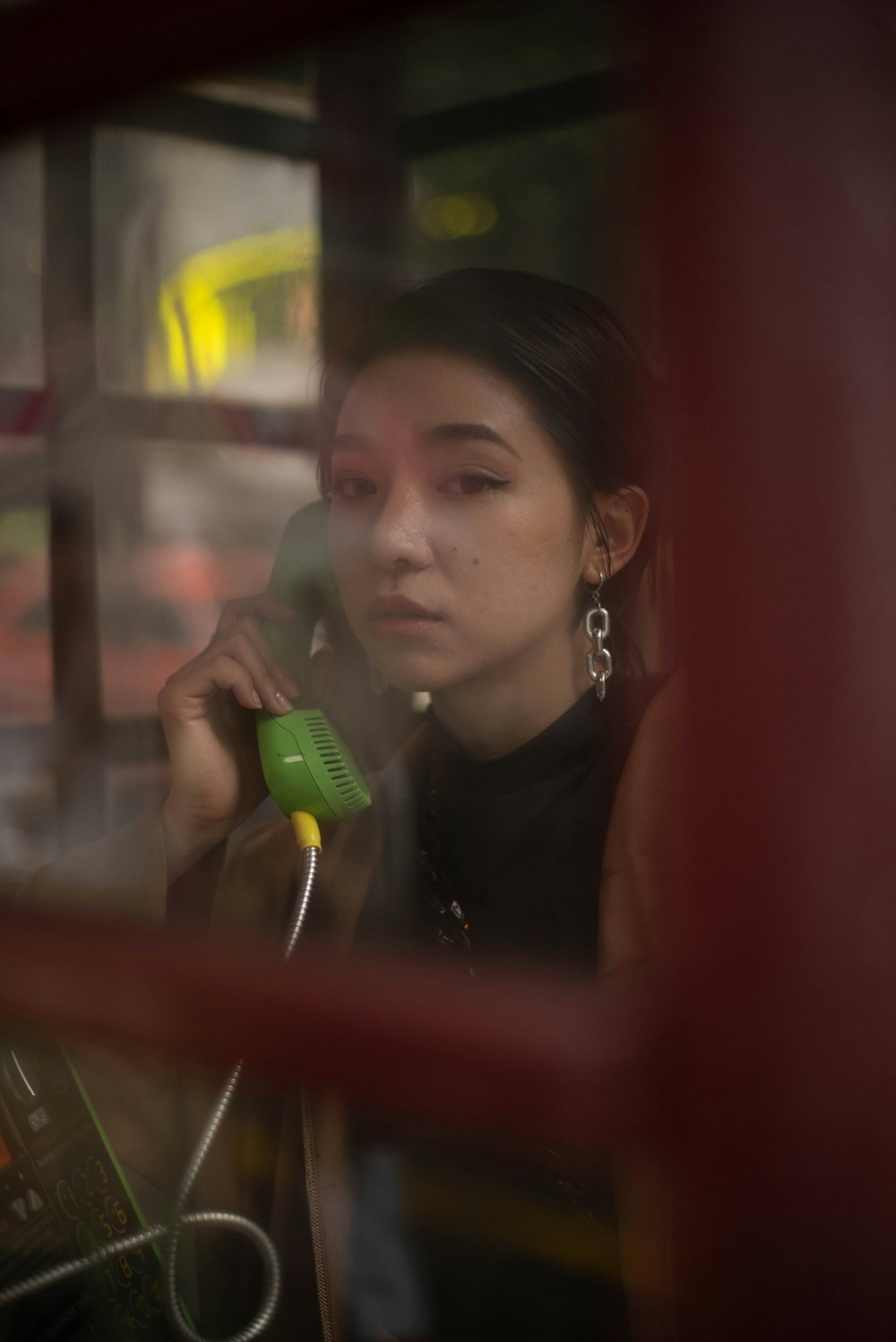 a woman talking on a cell phone while sitting in a bus