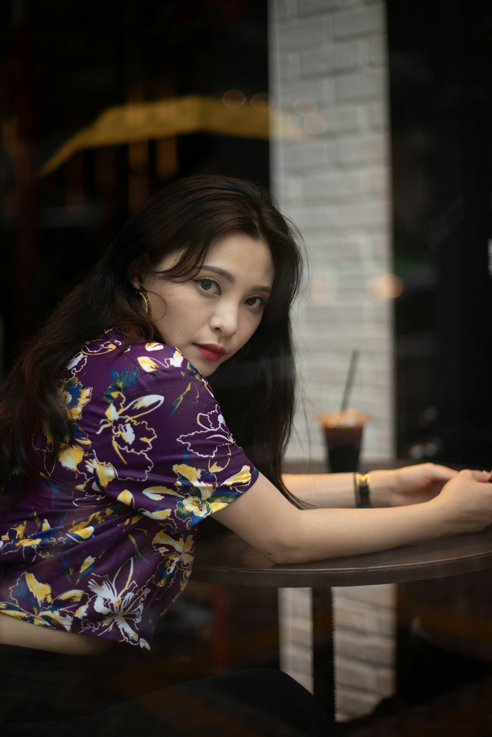 a woman sitting at a table in a restaurant