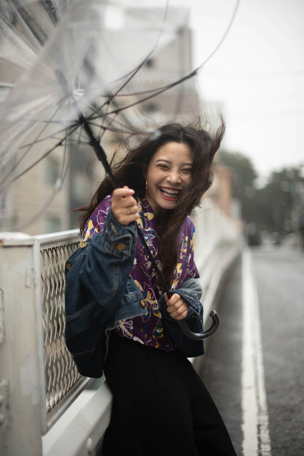 a woman is holding an umbrella and smiling