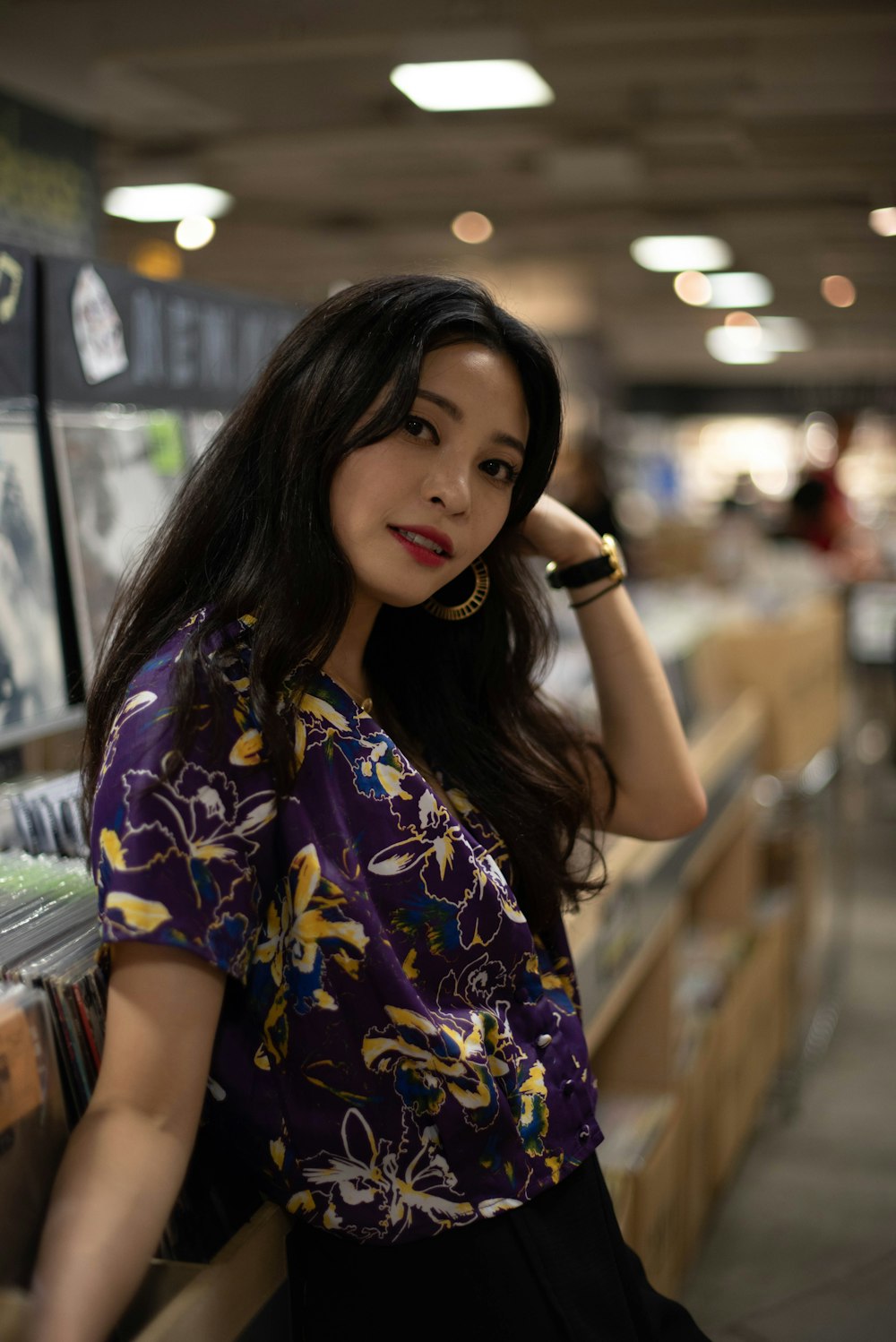 a woman leaning against a wall in a store