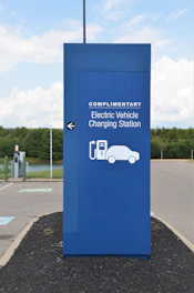 a blue sign with a car charging station on it