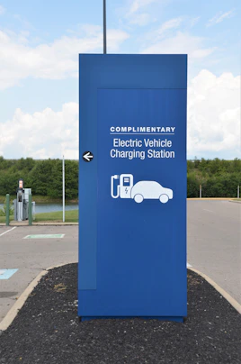 a blue sign with a car charging station on it