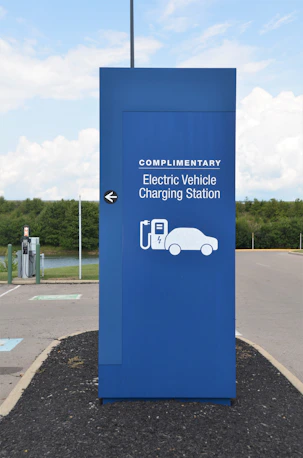 a blue sign with a car charging station on it