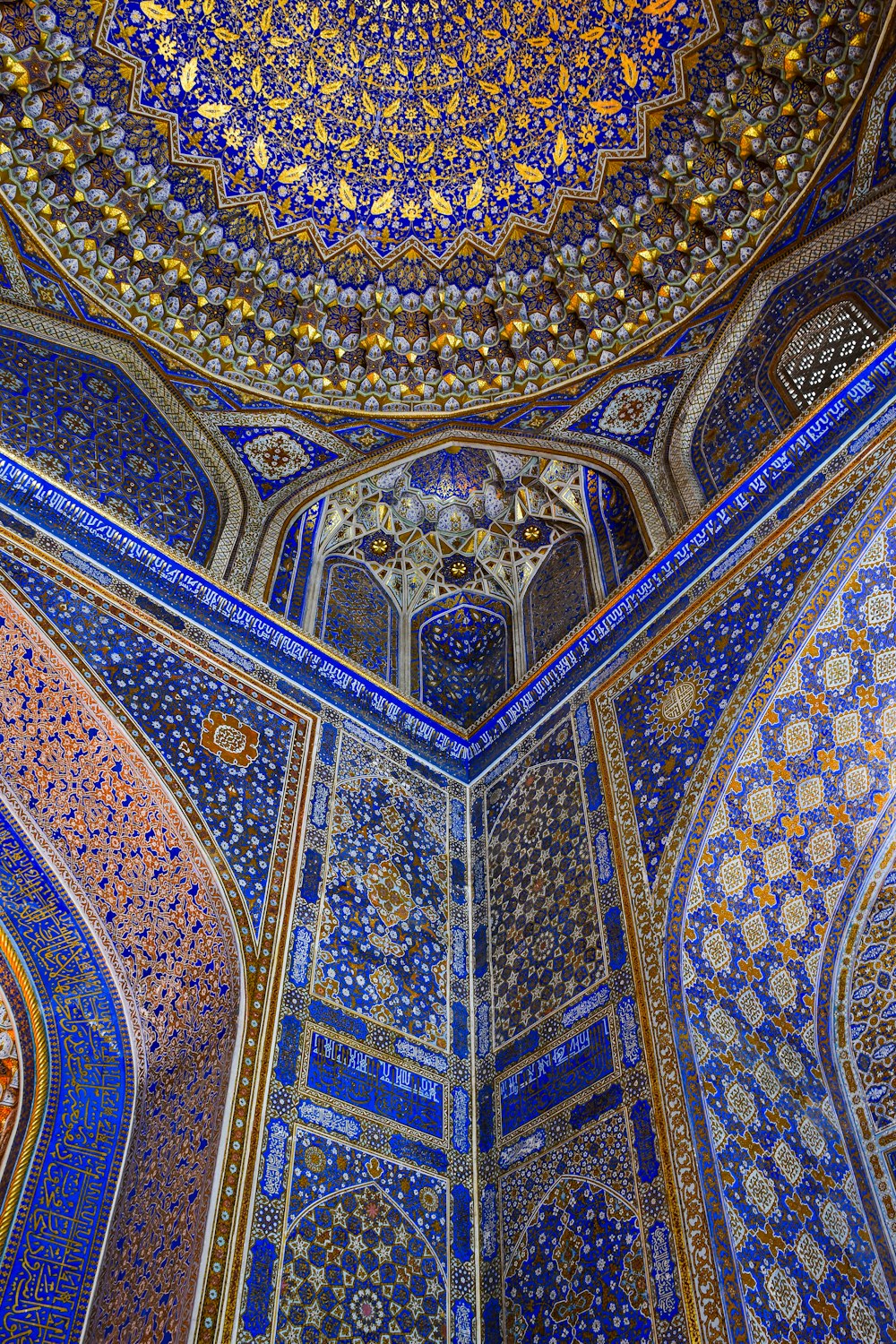 the ceiling of a building with blue and gold designs