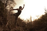 An outdoor scene of a woman performing expressive dance.
