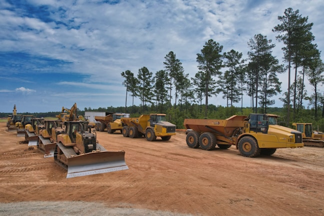 A fleet of construction vehicles lined up ready for deployment.