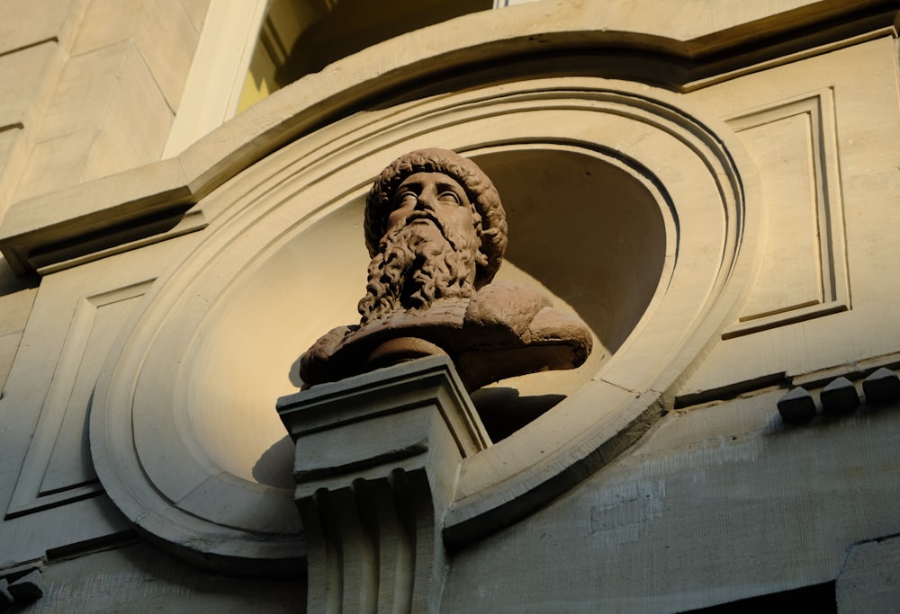 a statue of a man with a beard on a building