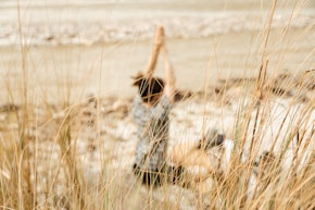 a person standing in a field of tall grass