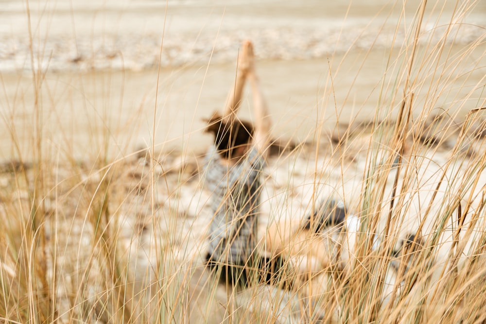 a person standing in a field of tall grass