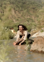 Solo yoga practice on the banks of the River Ganga in Rishikesh, embracing peace and spirituality