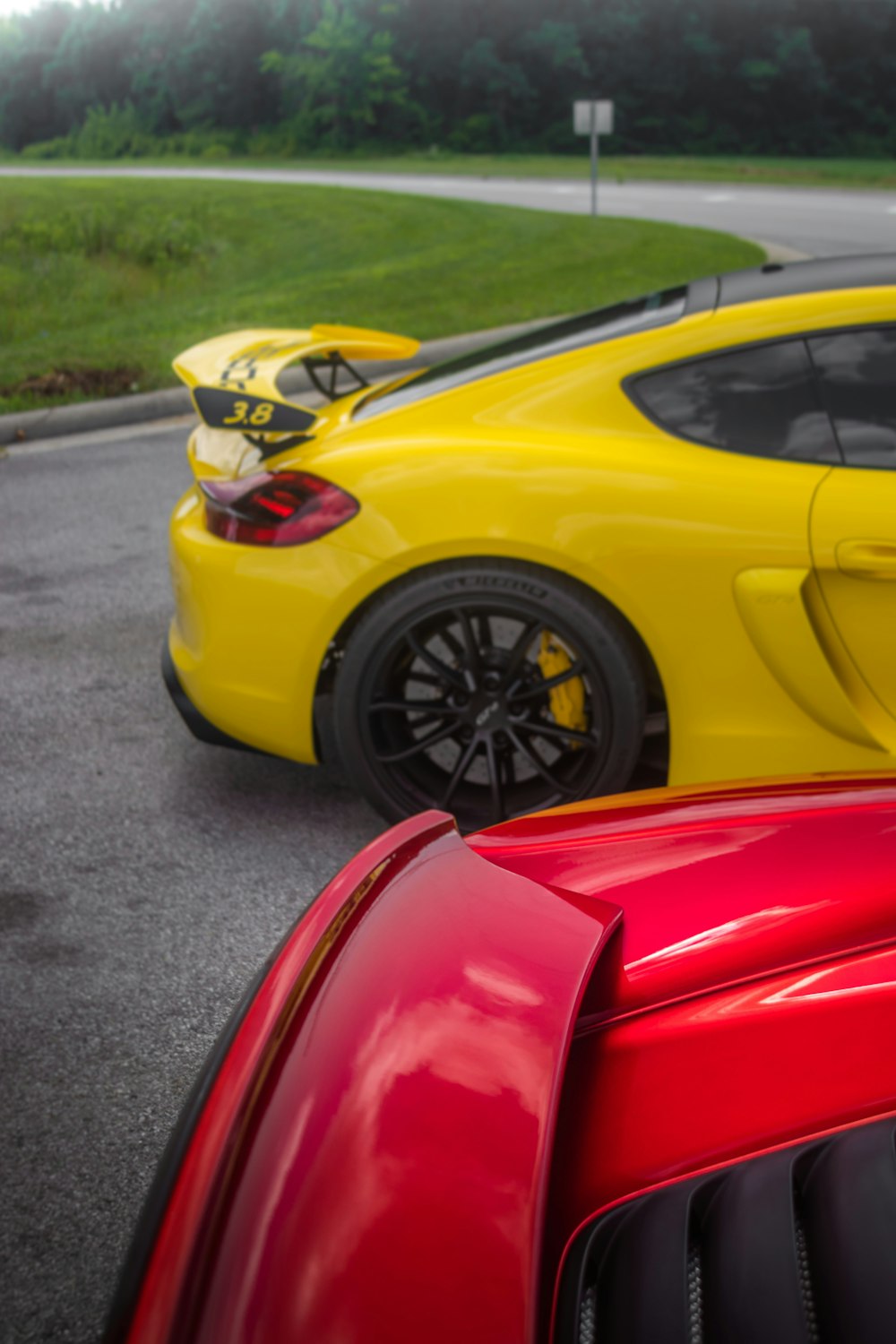 a yellow sports car parked next to a red sports car