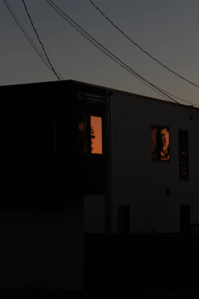 A twilight shot of Goga Heights Smart Estate Wuye, showcasing illuminated modern homes against a deep black sky.