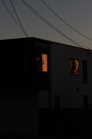 A nighttime shot of a home lit by solar-powered lights, showcasing energy independence.