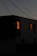 A vibrant twilight shot of a luxury home glowing warmly against a dusky sky.