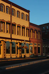 A close-up of a beautifully restored historic building facade on South Flower Street bathed in warm sunlight