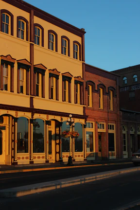 Historic filanda building exterior bathed in soft golden afternoon sunlight.