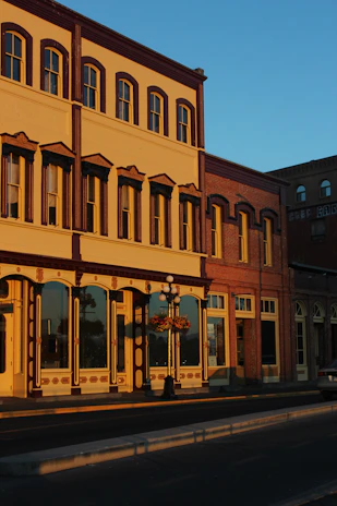 Historic storefront of Barocco’s Clothing on North Main Street, Fairport, bathed in warm afternoon light.