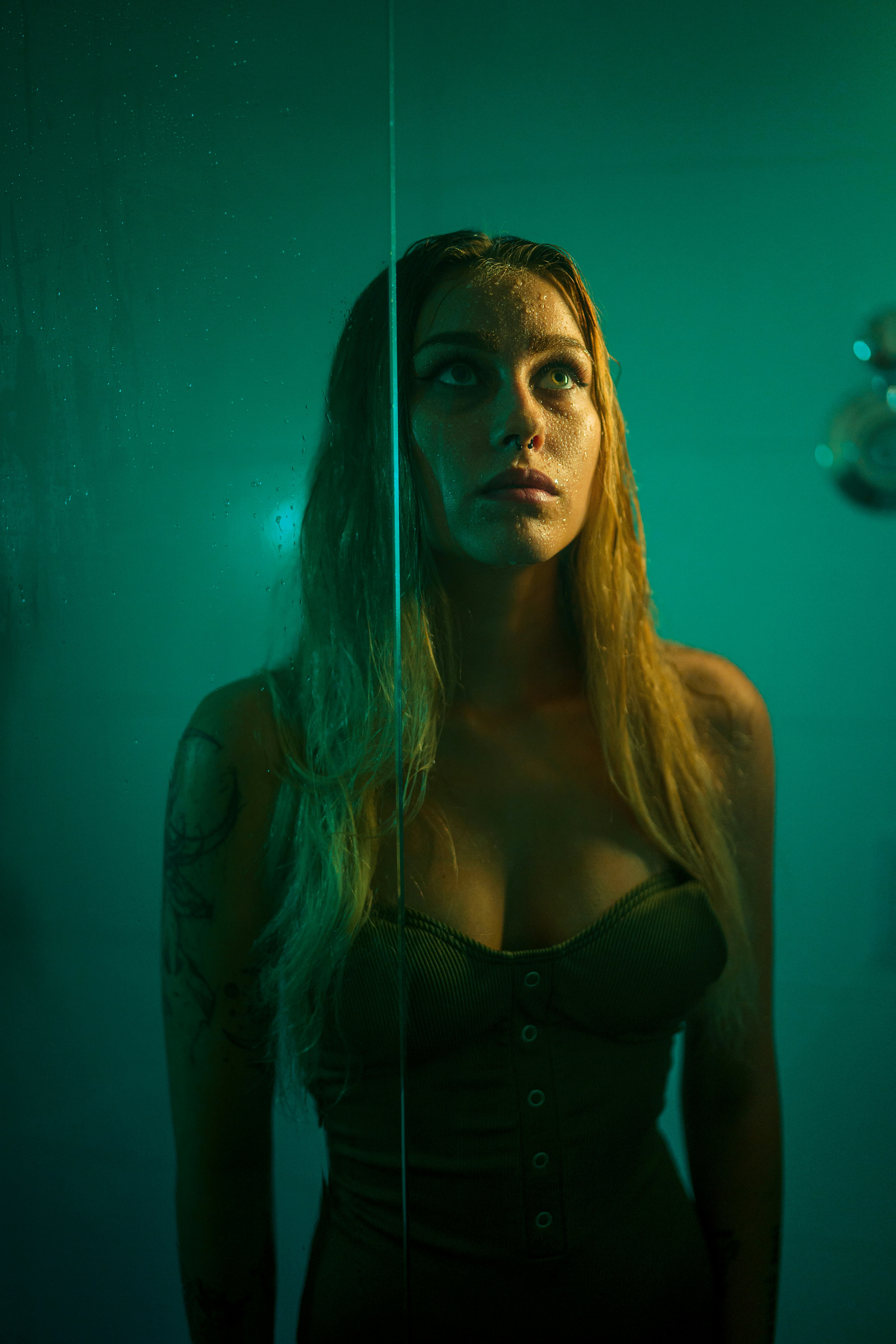 a woman with long hair standing in front of a mirror