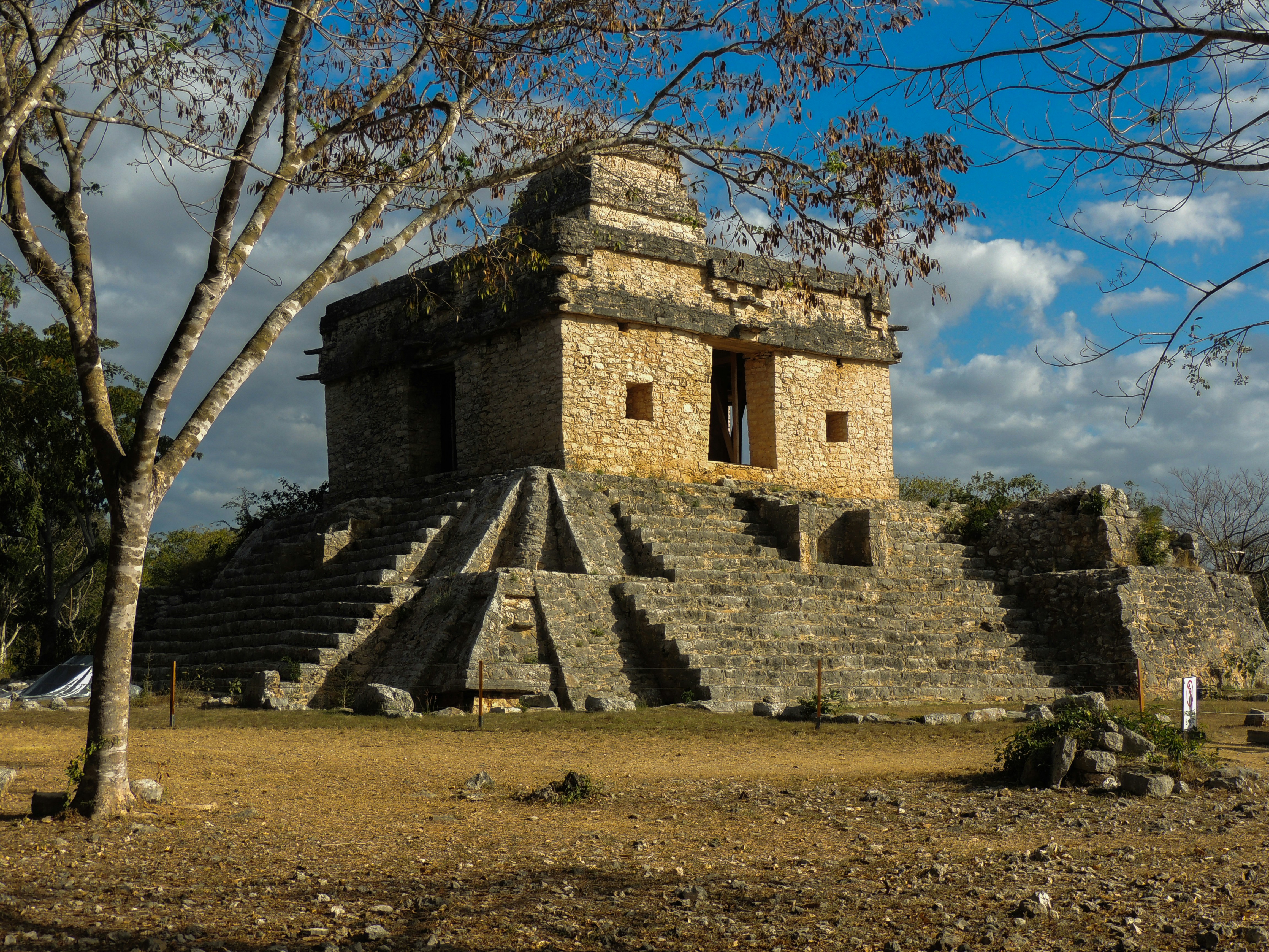 a stone structure in the middle of a field