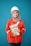 A person wearing a bright red industrial jacket with reflective stripes and a white safety helmet. They are holding a book titled 'Occupational Safety and Health Act' against a plain blue background. The person is smiling and the jacket has a logo on the chest.