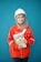 A person wearing a bright red industrial jacket with reflective stripes and a white safety helmet. They are holding a book titled 'Occupational Safety and Health Act' against a plain blue background. The person is smiling and the jacket has a logo on the chest.