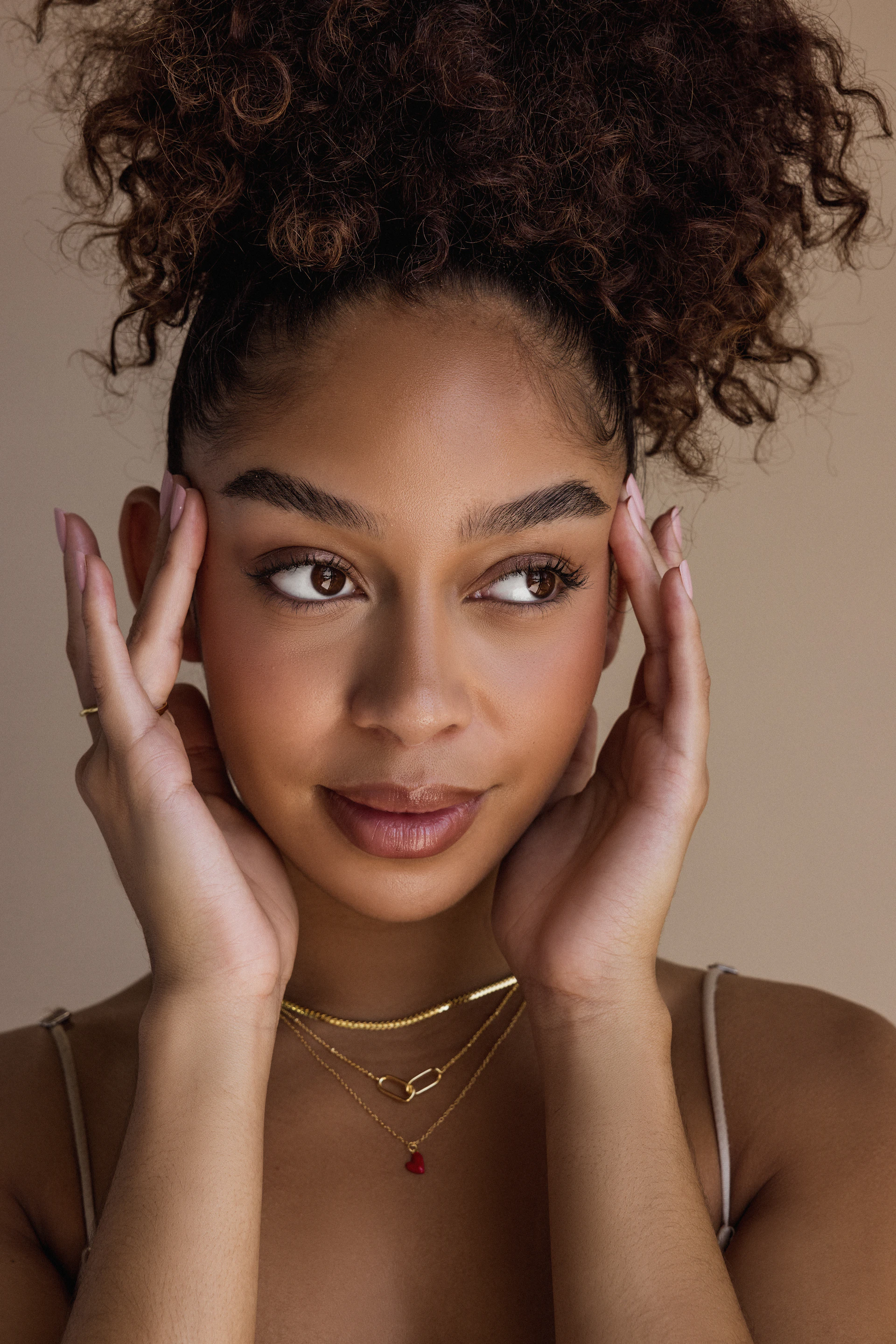a woman with a necklace and a necklace on her neck