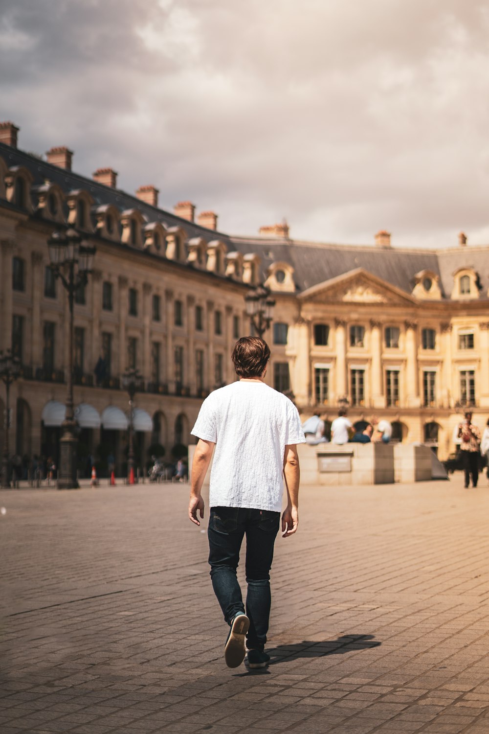 a man walking down a street in front of a building