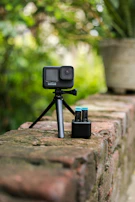 A content creator setting up a camera on a tripod next to a sleek e-bike.