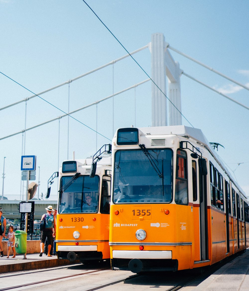 a couple of buses that are sitting on the tracks