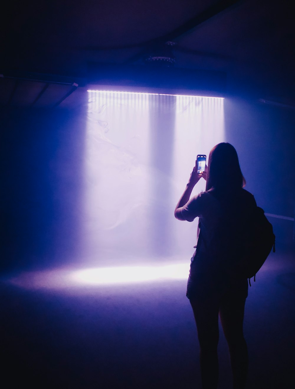 a person taking a picture of a light with a cell phone