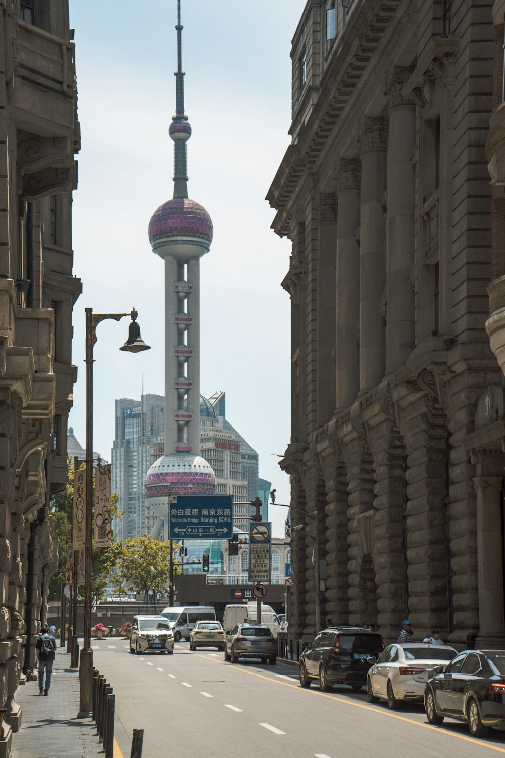 a city street with a tall building in the background