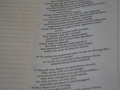 A close-up view of a page from a book with text in a serif font. The text is aligned in a single column with a justified layout, and there are dotted lines on the left side of the page.