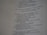 A close-up view of a printed page with text in English. The text appears to be from a religious scripture, specifically verses or passages, with some words in bold.