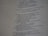 A close-up view of a printed page with text in English. The text appears to be from a religious scripture, specifically verses or passages, with some words in bold.