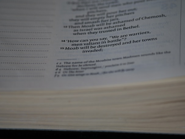 Close-up of an old, leather-bound esoteric book with cryptic markings on the open page.