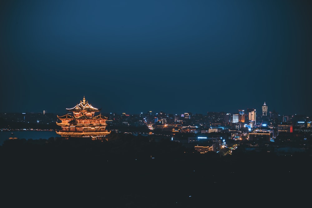 a view of a city at night from the top of a hill