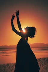 An elegant outdoor portrait with a dramatic sunset backdrop.
