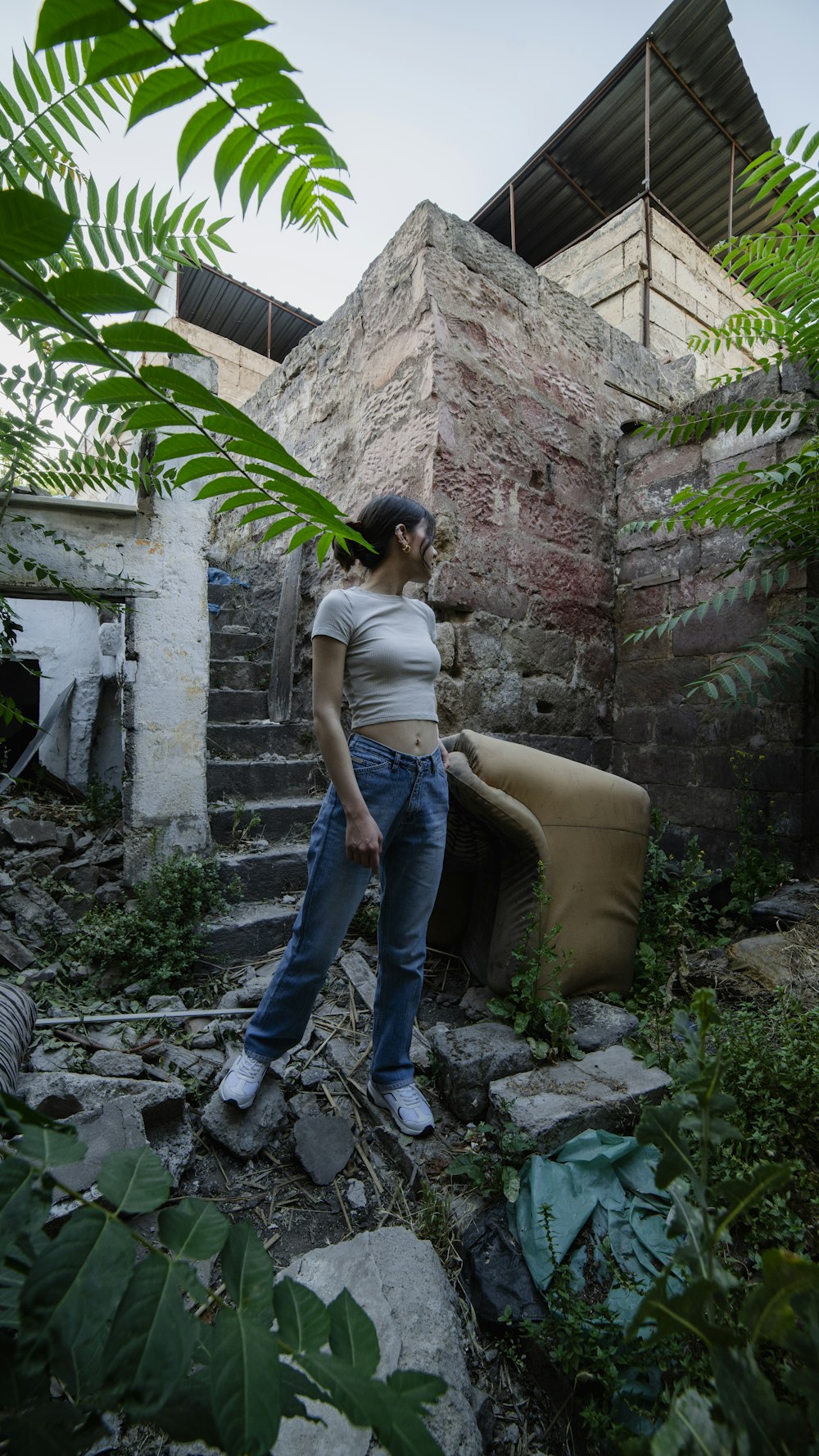 a woman standing in front of a stone building