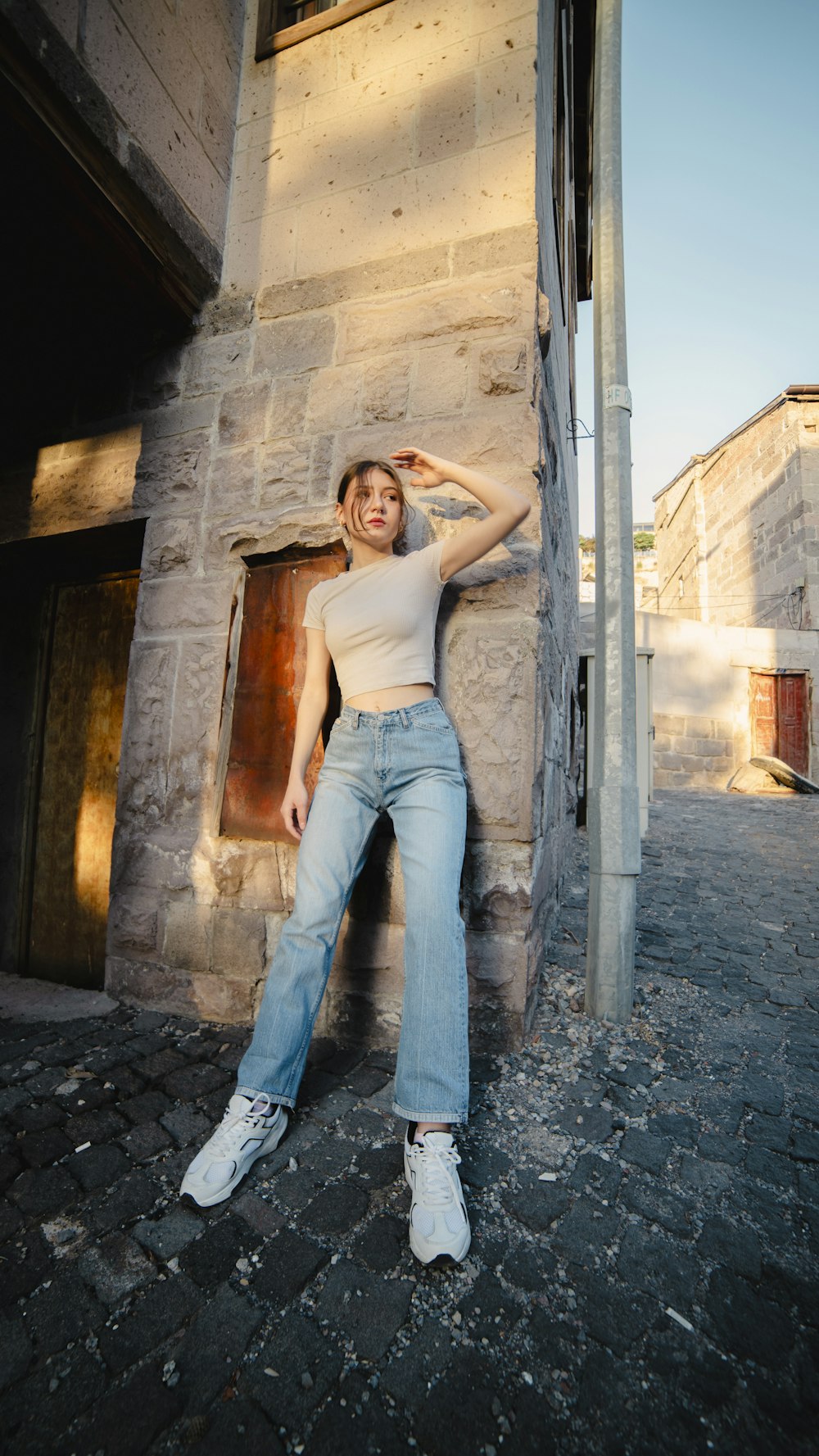 a woman posing for a picture in front of a building