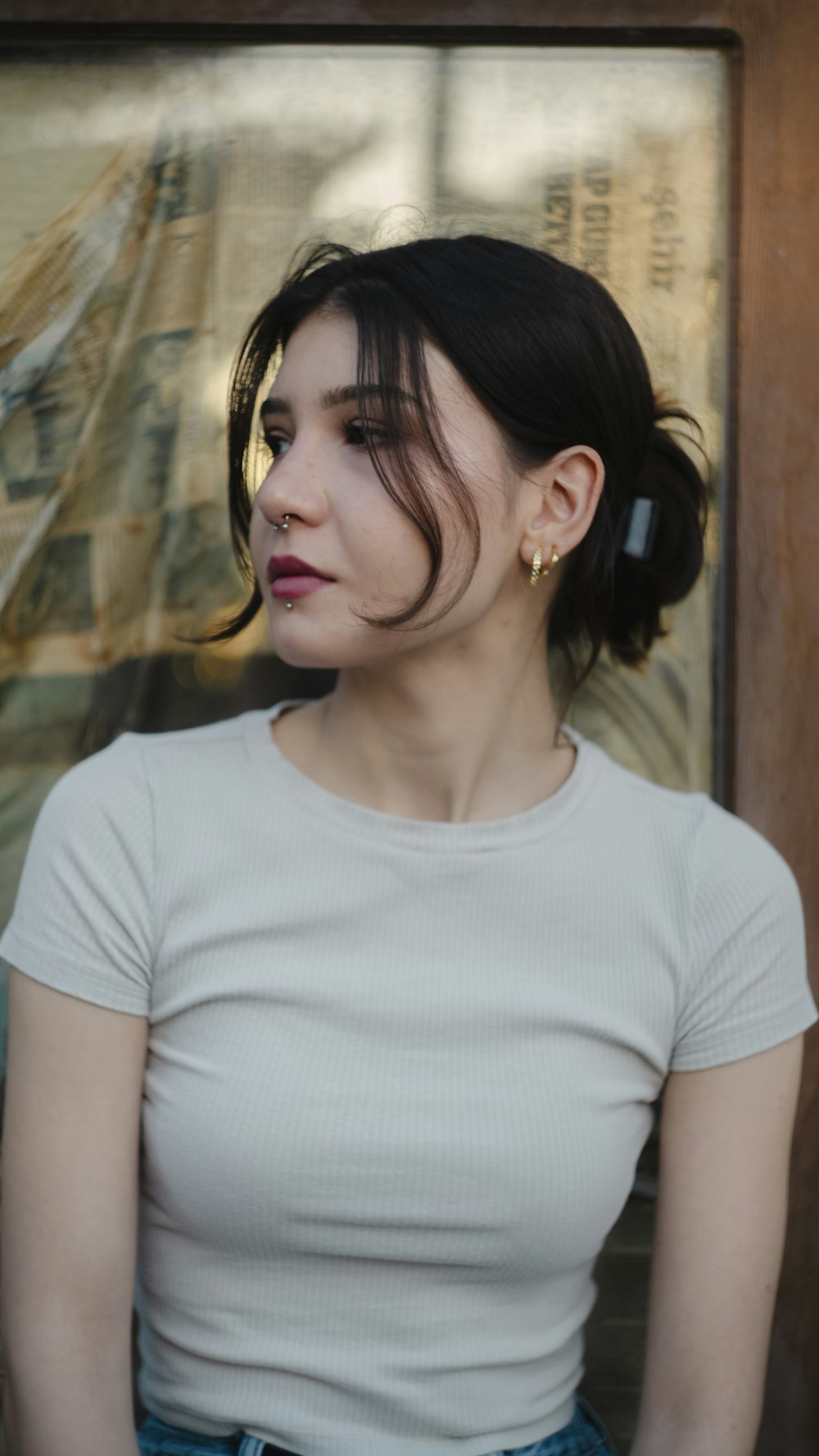 a woman sitting in front of a wooden door