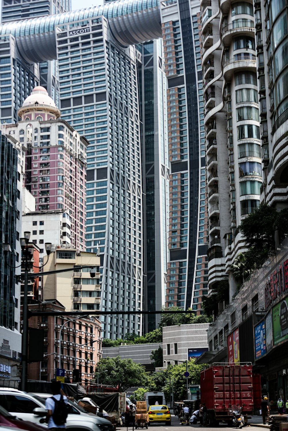 a busy city street with tall buildings in the background