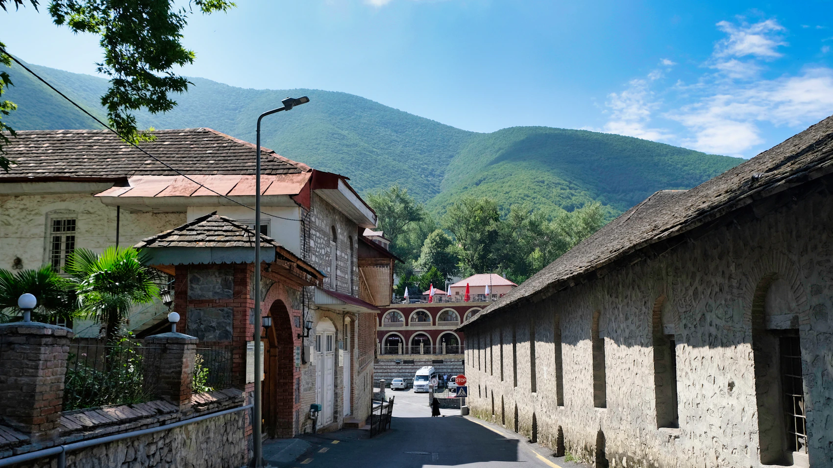 Stone-lined street with Caucasus mountains in Sheki, Azerbaijan