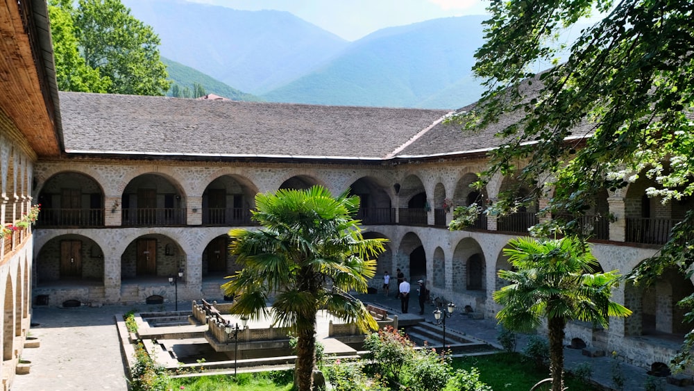 a courtyard of a building with a fountain in the middle