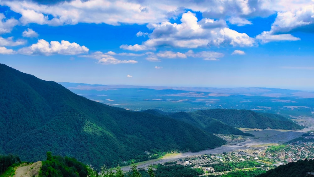 a scenic view of a valley and mountains