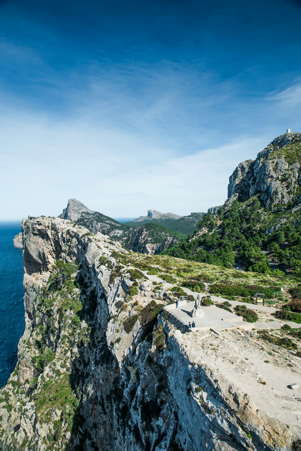 a rocky outcropping with a body of water in the background