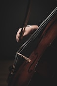 a close up of a person playing a cello