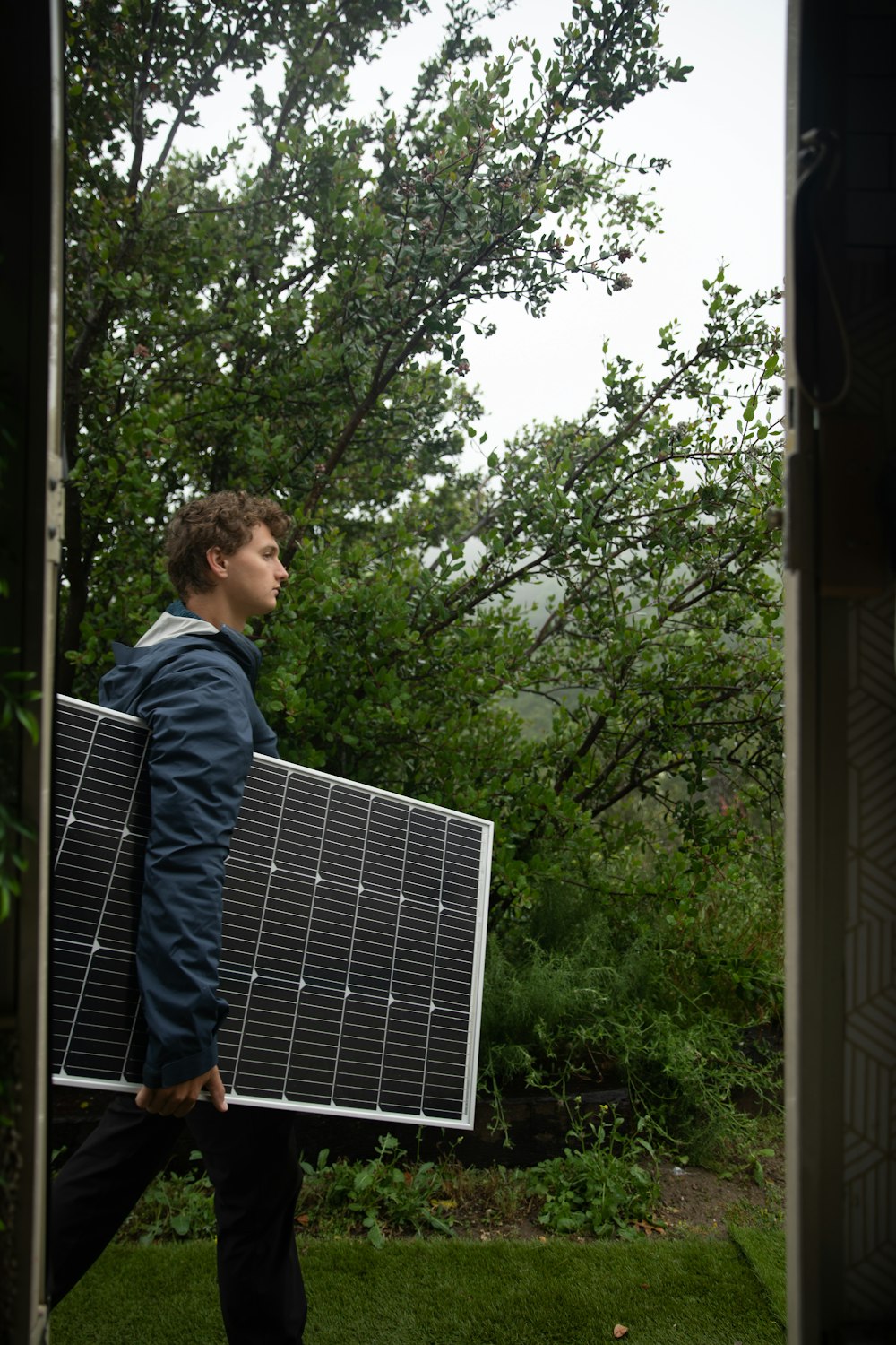 a man carrying a solar panel on his back