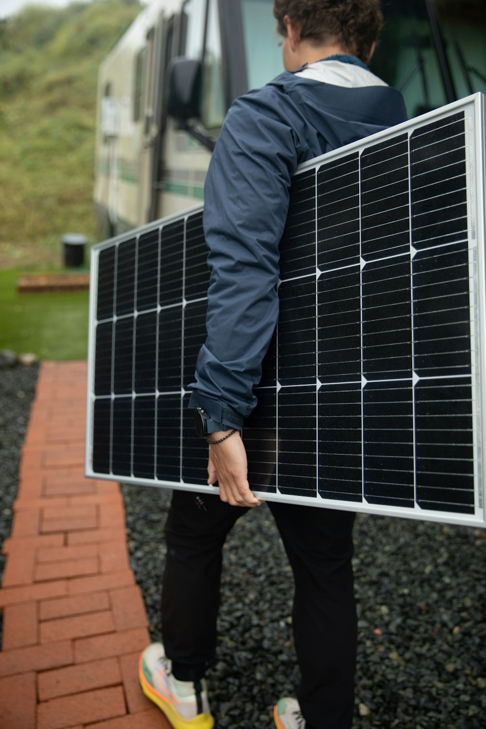 a man carrying a solar panel on his back